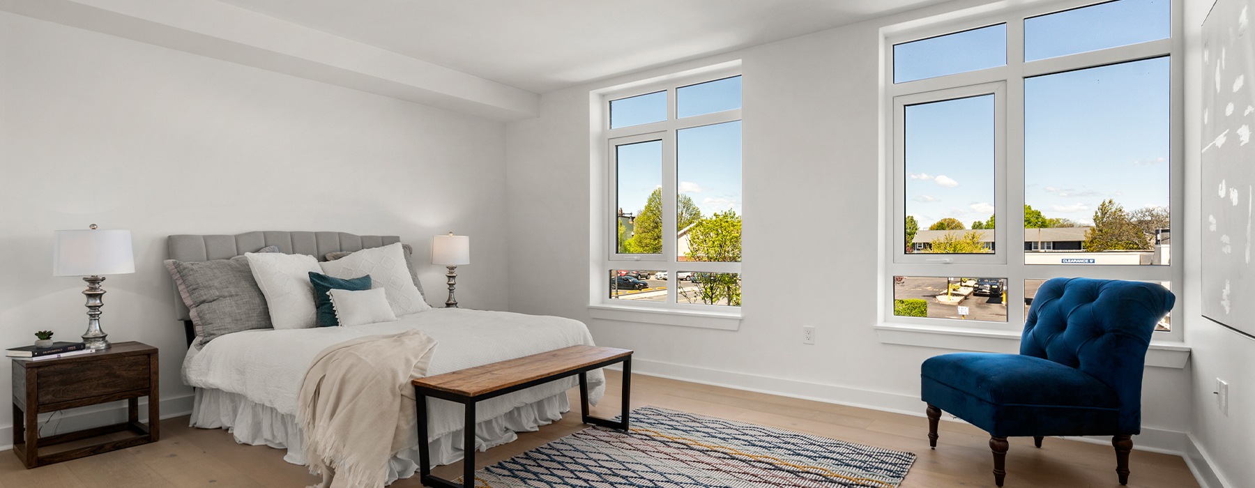 Rendering of a spacious and well lit bedroom with large windows