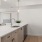 Spacious Kitchen with stainless steel appliances adjacent to large windows. 