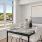 Spacious naturally lit dining area with large windows overlooking East Boston