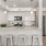 Spacious kitchen with bar and stainless steel appliances.