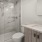 Large well lit bathroom with spacious walk in shower.