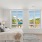 Spaciouse naturally lit bedroom with wood floors and large windows overlooking East Boston.