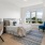 Spacious and well lit bedroom with plush carpet and large windows