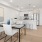 Spacious and well lit dining area with wood floors and large windows 