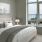 Spacious and naturally lit bed room with large windows overlooking the ocean