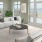 Spacious and naturally lit living room with large windows and a ocean view